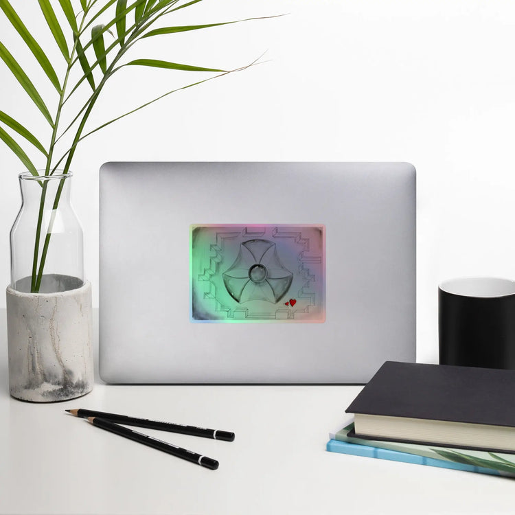 Holographic stickers featuring biohazard symbol and red hearts on a laptop with artwork
